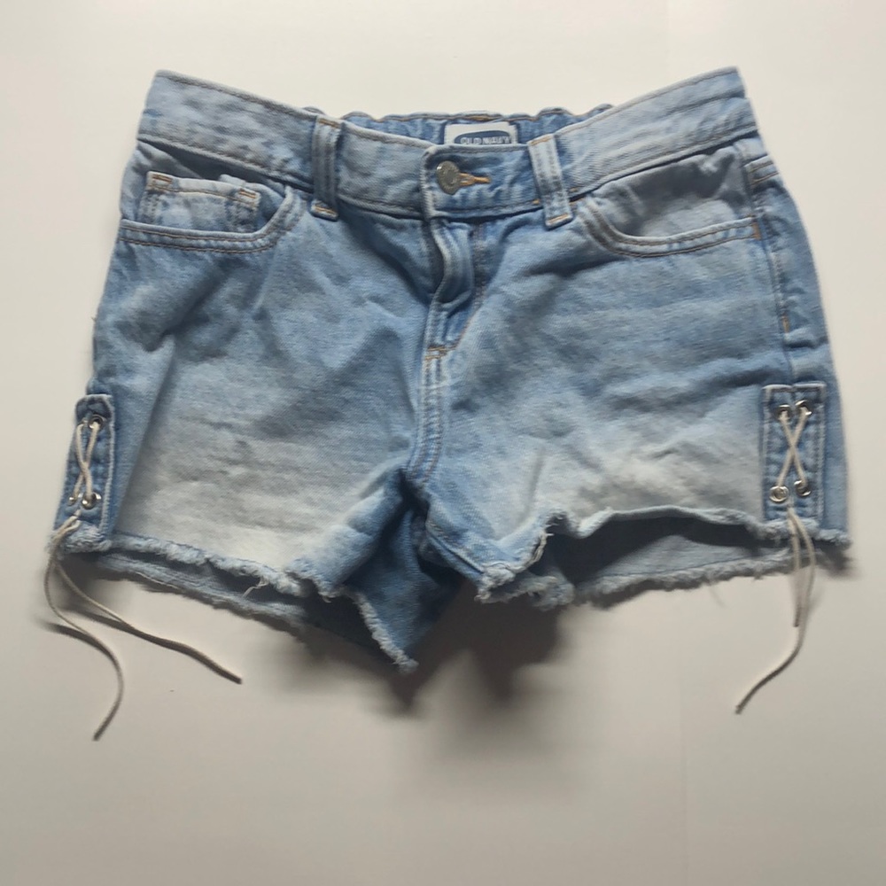 Old Navy Ripped blue Jean shorts with tie designs on the sides. Size 12 girls